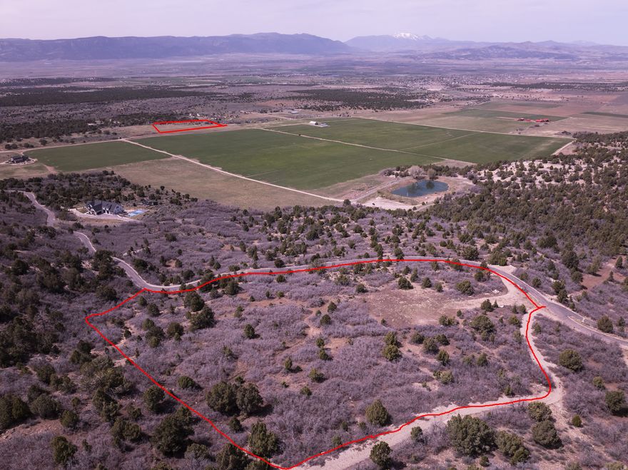 Discover one of the premier view properties in all of Sanpete County, offering breathtaking, unobstructed panoramas of the valley and surrounding mountains. This unique opportunity includes two parcels totaling 9.90 acres-a 6.07-acre buildable homesite paired with a 3.83-acre pasture lot, giving you the space, flexibility, and privacy that are increasingly hard to find.  Located within a private gated community, this property delivers both security and a peaceful, rural lifestyle. Enjoy access to a community pond and shared gathering areas, perfect for relaxing, entertaining, and taking in the natural beauty that surrounds you.  Power and culinary water are stubbed to the lot, and the HOA includes culinary water use, adding significant long-term value and convenience. With year-round access, this is an ideal location for a full-time residence, second home, or legacy property.  Opportunities like this-combining top-tier views, usable acreage, gated access, and valuable utilities already in place-are rare in today's market.