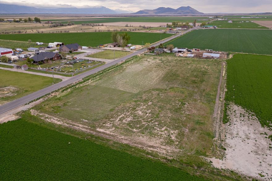 Set on 3.00 acres in unincorporated Box Elder County, this property offers the kind of space and flexibility that's getting harder to find. It's well suited for a custom home, hobby farm, or horse property, with a valuable Penrose and Thatcher culinary water share already in place. The setting opens to wide, panoramic mountain views, with plenty of room for animals, outbuildings, and equipment. You get the quiet and privacy of a rural landscape, along with easy access to nearby towns when needed. Sunsets stretch across the horizon, nights bring clear, star filled skies, and the land gives you the freedom to build exactly what you have in mind. Opportunities like this, with acreage and a reliable water source, don't come around often.