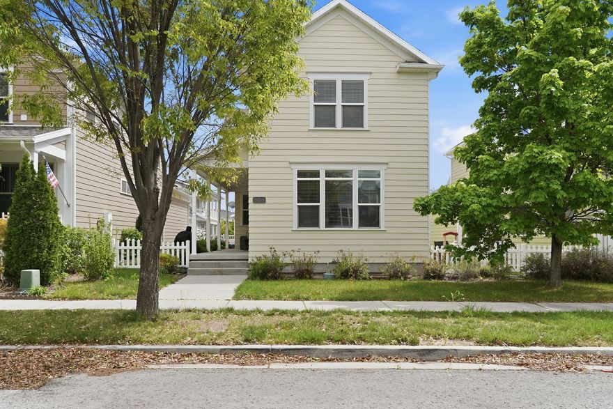 Situated in the highly desirable Daybreak community, this home showcases one of the area's most popular floorplans and a thoughtfully upgraded interior. The main level offers an open-concept design with beautiful bamboo flooring, a bright living space, dining area, half bath, and a well-appointed kitchen featuring quartz countertops, stainless steel appliances, tile backsplash, and abundant natural light. Upstairs includes three spacious bedrooms along with a versatile loft. The primary suite is generously sized with dual walk-in closets and an en-suite bath complete with double sinks, a soaking tub, and separate shower. Enjoy relaxing on the covered front porch, plus the added bonus of a large cold storage room. The home is surrounded by inviting shared green spaces, perfect for outdoor enjoyment, and includes access to Daybreak's exceptional amenities such as pools, parks, trails, fitness center, sports courts, gardens, and more