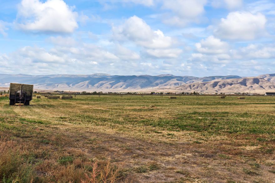 Once-in-a-lifetime buildable lot with stunning mountain views just outside of Monroe! This productive 5-acre county parcel of farm land includes 3 shares of Monroe Irrigation Canal water, with additional shares or an underground water right that can be negotiated separately. Close to town for convenient access to schools and stores, yet completely private - it's the perfect location if you're looking to build your forever home with enough room for livestock and pasture. The land is ideal for crops such as alfalfa, pasture grass, or small grains, with a proven history of strong yields. And if you want even more land, there are two other larger contiguous parcels available to the north and west (see MLS# 2114518 for full 40 acres). Excellent accessibility from a well-maintained county road. Zoned for agriculture, but close to city limits for potential annexation opportunities in the future. Don't miss out! Buyer to verify all information.