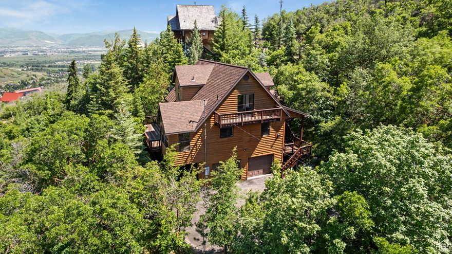 Tucked near the summit of Interlaken, this cozy cabin retreat offers the perfect blend of seclusion and convenience-just minutes from town, yet surrounded by nature. With year-round access, it's an ideal mountain escape whether you're seeking a second home or a peaceful full-time residence. Enjoy the crisp mountain air and serene views from one of five private decks. Inside, a warm and inviting layout includes a versatile lower-level space that opens to its own deck-perfect for a game room, movie nights, or simply unwinding after a day outdoors. This is your opportunity to experience mountain living in every season.