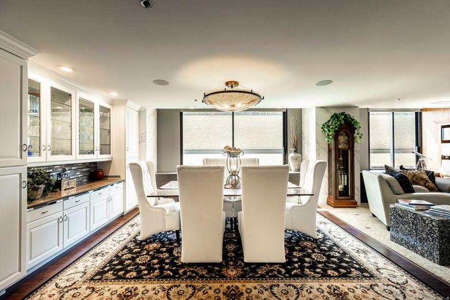 Welcome to one of the most exceptional residences ever offered in American Towers. Perched on the 14th floor of the South Tower, this fully reimagined condo is the only home of its kind-a modern, high-design retreat with 270-degree mountain and city views that stretch from sunrise to skyline sparkle. Completely taken down to the studs and completed in 2023, this home was rebuilt with premium materials and custom architectural details throughout, including Neolith stone cladding, engineered walnut flooring, mahogany doors with forged hardware, and upgraded lighting at every turn. The result is a residence that feels timeless, solid, and intentionally crafted. A full Control4 smart-home system runs the entire space-whole-home audio, independent video distribution, Italian-made motorized blinds, and integrated automation that makes day-to-day living effortless. Inside, the intelligent floor plan offers three bedrooms and three bathrooms, including a concealed office/guest suite and a luxurious primary retreat. Floor-to-ceiling windows fill the home with natural light and frame the evolving downtown landscape. A standout feature of the home is the professional-grade Dolby Atmos theater, complete with a 13.5' motorized screen, hidden Nexus projector lift, acoustic wall panels, luxury reclining seating, blackout blinds, and an LED starfield ceiling-an unparalleled cinematic experience rarely found in high-rise living. Additional highlights include two real-flame EcoSmart fireplaces, a fully upgraded kitchen with cherry cabinetry and quartzite counters, and a thoughtfully designed dining and living space built for both comfort and entertaining. American Towers offers unmatched convenience with 24/7 staffed security, secure underground parking (1 dedicated stall included; additional spaces available for rent), two rooftop terraces, an indoor pool, spa, sauna, fitness center, racquetball courts, and inviting community lounges. Located in the heart of downtown-just steps from the Eccles Theater, City Creek, award-winning dining, shopping, and TRAX-this residence delivers elevated living without compromise. A rare opportunity to own an award-winning, 2024 Parade-of-Homes-featured condo in one of Salt Lake City's most iconic towers. Homes like this simply don't come around twice.  Nearly all furniture and dcor seen in the home are included in the sale; a detailed inventory list can be provided upon request. Be sure to explore the two virtual tours provided.