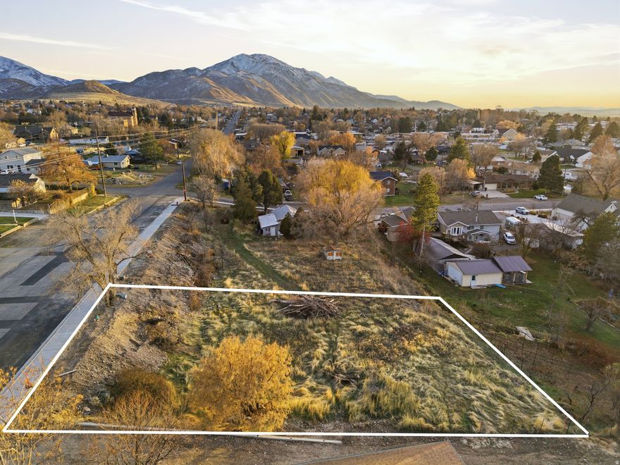 Great opportunity to build in the heart of Payson. This .24 acre parcel (55:959:0003) is part of a small development where curb, gutter, and all utilities will be stubbed and available. Development is currently underway and scheduled to be completed before November.  The location is ideal with quick access to I-15, Mountain View Hospital, and all the amenities of downtown Payson. Whether you're a builder looking for your next project or a buyer wanting to design your own home, this lot offers excellent potential in a prime spot.