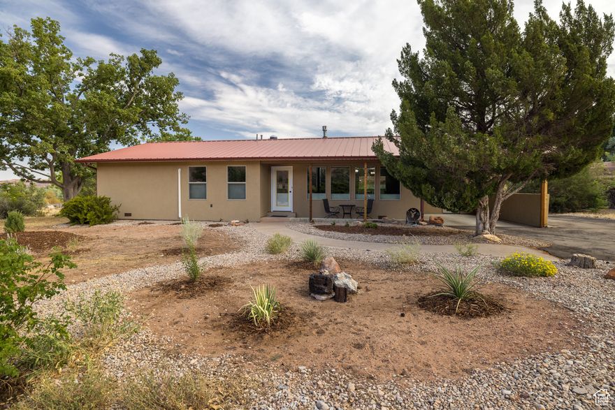 ADORABLE ACRE- Set on a peaceful acre abutting conservation land, this absolute charmer has been completely refurbished to be exceptionally fresh and modern. Bask in the Moab Rim view from the living room with a cozy gas stove.  Create exceptional meals in your brand new kitchen with new appliances, granite counters, soft-close cupboards and drawers. Sleep comfortably in your en-suite bedroom with updated bathrooms, walk-in shower and pasture views. So much room to grow, plant gardens, add additional structures- you can bring your horses too! New doors, trim, windows, up/down blinds, and luxury vinyl tile throughout. Functional and efficient updates include four mini-splits for individual room climate control, upgraded ceiling insulation, new electrical panel, and fresh stucco exterior. This home is ready for you to come and enjoy the quiet.