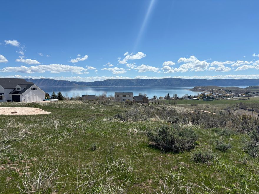 Picturesque Bear Lake-view cul-de-sac lot, outside of an HOA! Paved access road is year-round-maintained, peaceful, and slow. Short term rental friendly! The vast majority of lot is flat ground, but has the perfect steep drop off on the southeast of lot, protecting your lake view forever! Water, sewer, and power all stubbed right to the lot, making your building experience much simpler. Ride trails in the beautiful Hodges Canyon without entering highway. Come see the wide, expansive views of the lake and mountains yourself! This is quite literally the whole package!