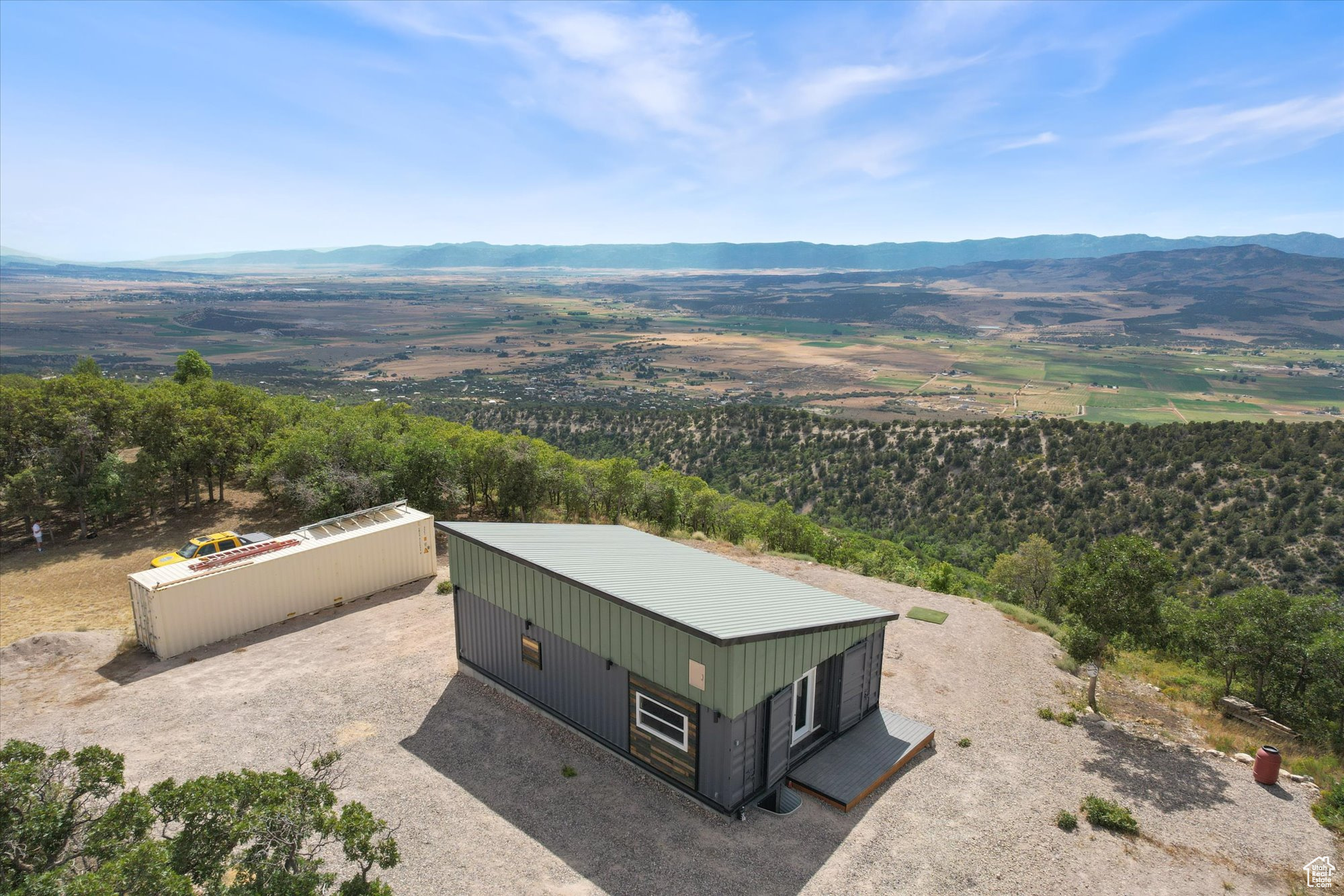 Modern Mountain Retreat with Unmatched Views Ready for Your Final Touch Perched high in the mountains with sweeping valley and mountain vistas, this striking home combines bold, modern architecture with the strength and sustainability of three 40' Conex containers. Its finished exterior-with pitched roof, wood accents, and sleek steel siding-blends contemporary design with rugged durability, making it as eye-catching as it is enduring. The interior is framed, wired, and plumbed, and is nearly ready for a 4-way inspection-giving you the rare opportunity to finish the space exactly to your taste. The planned design includes a spacious great room with panoramic window views, a modern kitchen, a private primary suite, a second bathroom, and a laundry area. Also included is a separate 40' Conex container setup as a workshop, perfect for storing toys and supplies, or future expansion. This property is a great vacation getaway in one of Utah's most scenic mountain settings. 100A Power is connected and a 1000 gallon septic system is already installed. Water would be hauled from a nearby fill station or delivered with 2 IBC tanks (275 gallons each) included. Skyline Mountain resort is located at the foot of the Manti-LaSal mountains just minutes from Fairview and Mt Pleasant with grocery stores, restaurants, a hospital, aquatics center, drive-in theater, and every type of recreation you can think of (fishing, hiking, biking, ATV, snowmobiling, mountaineering, etc.)