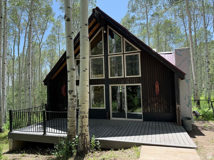 Leave the craziness of life and escape to this getaway on a heavily-wooded aspen and pine tree lot.  Located behind Deer Valley East Village and 4 miles from Park City, this dry A-frame cabin is a cozy retreat, ready for you to finish into the perfect hideaway. The kitchen has granite countertops, new cabinets and a beautiful sink with copper detailing.  Two bedrooms on the main with a full bath with tile work nearing completion. Upstairs are two more bedrooms, a half bath to be finished and a loft area overlooking the downstairs. New double-pane windows and roof was taken down to the studs and reworked with a new metal roof.  There is no water plumbed to the cabin however there is one water right that can be used to dig a well. There is a septic tank in place already and a water heater that is not hooked up yet. Large deck out front for enjoying the peace. Bring your vision: this cabin's solid bones and charming details can be a blank canvas for custom upgrades, solar off-grid systems or even a modest expansion. Adventures begin at your doorstep: you're minutes from hiking trails, fishing creeks, ATV/motorcycle routes and endless mountain vistas. This slice of Utah's high country is the ultimate backdrop. Located on the paved road so easy access much of the year. Winter access is snowmobile only.  Don't just visit the mountains - own them!