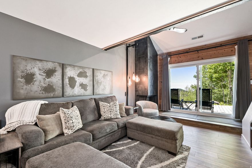 Mountain Retreat Townhome - No Steps Required Step directly into this charming rustic farmhouse-style townhome featuring one bedroom plus a loft, 1.5 bathrooms, and soaring vaulted ceilings filled with distinctive character. Thoughtful details show throughout every corner, revealing carefully chosen amenities: a spacious walk-in closet, stunning custom tilework, and a built-in wall safe for peace of mind. Modern conveniences include remote-controlled ceiling fans, automated window shades, and an integrated Bluetooth speaker system in the powder room. The thoughtfully designed layout provides comfortable sleeping for up to six guests across three distinct areas: the master bedroom with king bed, the loft featuring a full bed, and the living area with a queen sleeper sofa. Each sleeping space offers privacy and comfort. This coveted corner unit maximizes natural light through abundant windows, while the expansive 400-square-foot semi-private deck serves as an outdoor sanctuary perfect for grilling or simply taking in the breathtaking mountain and canyon vistas. The impressive 8-foot sliding glass doors seamlessly blend indoor and outdoor living spaces. Tucked away from busy streets among stately cabins, the property offers frequent wildlife sightings, deer, foxes, and other native creatures, while maintaining easy access to town with just a 15-minute stroll to the center. The HOA handles all exterior maintenance, landscaping, and snow removal for walkways and parking areas. Recent upgrades include a beautifully remodeled community laundry facility, and the complimentary shuttle service with pickup at the property entrance makes exploring town effortless. This pristine unit has never been part of a rental program and remains exclusively used by the owners and their family, ensuring exceptional care and maintenance.