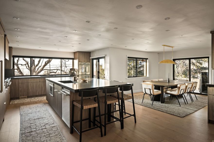 Completely reimagined in 2024, this East Bench residence was taken down to the studs and rebuilt with intention, quality, and timeless design at the forefront.  Located in one of Salt Lake City's most established neighborhoods, 1404 Canterbury blends elevated craftsmanship with modern functionality. The heart of the home features a stunning chef's kitchen with custom cabinetry, natural stone surfaces, and high-end integrated appliances, designed for both everyday living and effortless entertaining. Clean architectural lines, warm wood tones, and curated lighting create a refined yet inviting atmosphere throughout.  The open-concept living spaces flow seamlessly to private outdoor areas, including a covered patio with fire feature, perfect for Utah evenings. Thoughtful design details continue into the primary suite and spa-inspired baths, where boutique-level finishes, soaking tub and steam shower, and custom tilework offer a true retreat experience.  Every system has been updated, including custom LED lighting, integrated Sonos audio throughout, electric blinds, and a whole-home water filtration system, bringing modern convenience without sacrificing aesthetic integrity.  Set just minutes from the University of Utah, downtown Salt Lake, and quick canyon access to Park City and world-class skiing, this home offers both elevation and accessibility.  1404 Canterbury Drive is not simply renovated-it is rebuilt, refined, and ready for its next chapter.