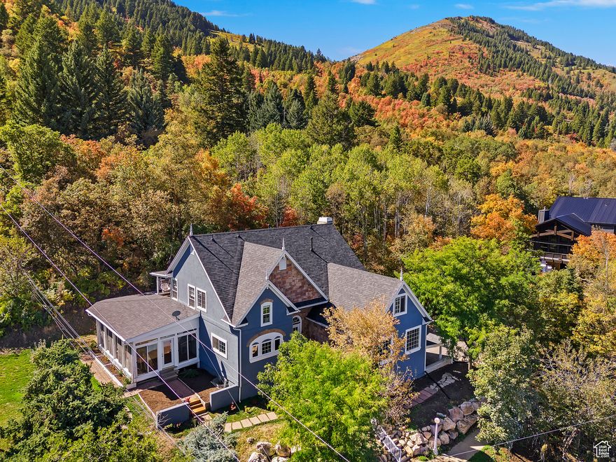Welcome to your mountain retreat in this beautiful home in the peaceful Spring Mountain Ranchettes of Eden. Set on 1.75 acres, the property features its own natural spring and a pond. With 6 bedrooms and 4 bathrooms, this home blends modern comfort with the beauty of its natural surroundings. The main level is bright and open, showcasing mountain views and offering an inviting space for entertaining. The primary suite is complete with a private balcony and a spa-like bathroom featuring a walk-in shower and jetted soaking tub. Additional bedrooms include a convenient Jack-and-Jill layout with generous closet space, plus a flexible bonus room ideal for a playroom, studio, or office. Thoughtful updates throughout the home bring a fresh, contemporary feel, including a fully updated kitchen (2022), new furnace (2022), roof (2024), flooring (2022), interior and exterior paint (2024), lighting (2024), and refreshed landscaping. The walk-out basement offers space for relaxing evenings, with custom-built library shelving perfect for reading or game nights. A spacious enclosed sunroom with a wood-burning fireplace adds year-round charm, while the outdoor patio invites you to unwind and take in the scenery. Outdoor recreation is right at your doorstep, with skiing just minutes away and easy access to nearby lakes for summertime fun. Plus, you're only a short drive from city conveniences like dining, shopping, and entertainment.