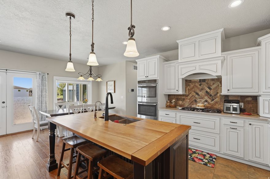 *PRICE IMPROVEMENT*. Nestled in a highly sought-after, well-established neighborhood on a .92 acre lot, this beautifully custom-built home offers the perfect blend of thoughtful design, comfort, and functionality. Lovingly maintained by its original owner, this newer home is packed with upgrades, flexible living space, and unique features throughout. Conveniently located within walking distance to the brand new West Field High School and near Haven Bay Elementary School and Mountain View Junior High School, this location offers both convenience and community.  Inside, you'll find spacious living areas, extensive built-ins throughout the home, a very large mudroom, and abundant storage space designed for both functionality and organization. Two cozy fireplaces and thoughtful custom touches make this home truly one of a kind - including a fun secret passageway connecting two of the main floor bedrooms and a full walk-through closet design in the basement. The primary suite offers private access to the back patio, creating a peaceful retreat with easy indoor-outdoor living.  The basement is filled with abundant natural light and is already plumbed for a future kitchen, creating excellent potential for multigenerational living, entertaining, or a future accessory apartment setup. The theater room is wired for surround sound with a dedicated media closet, and the communications hub is conveniently located in the mechanical room. The back deck is also wired for audio, perfect for gatherings and outdoor entertaining.  Designed for both convenience and future expansion, the home features paid-off solar, new HVAC, nine new windows, gas plumbed to the dryer, and 100-amp power ready for a future outbuilding or shop. The walkout basement patio is wired for a hot tub, and the property includes a thoughtfully designed sump pump system feeding the back fields, complete with a spare sump pump included.  Outdoor improvements include new exterior paint, fresh bark mulch, new gravel and park strip along the driveway, and a new deck railing. The oversized extra-wide garage comfortably accommodates 2.5 stalls with additional storage and workspace. Additional features include cold storage beneath the porch and plenty of open space to accommodate animals, gardening, recreation, or future improvements.  This exceptional property combines privacy, quality craftsmanship, modern amenities, and room to grow - all in a prime location where opportunities like this rarely become available.    Square footage figures are provided as a courtesy estimate only and were obtained from county records.  Buyer is advised to obtain an independent measurement and to verify all information.