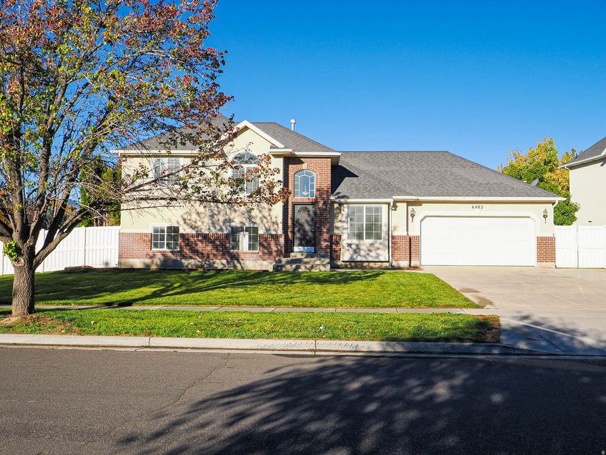 Beautifully updated, multi-level home on a spacious corner lot. Step inside to discover a bright, open floor plan with vaulted ceilings & tons of windows. The inviting family room features a cozy fireplace & large picture window perfect for gatherings or a quiet evening with loved ones. Enjoy the newly painted, soft white walls that brighten the space, along with brand-new carpet throughout the home. 3 large bedrooms & 2 full bathrooms, including the primary suite, are perfectly situated upstairs. The basement offers a comfortable family room & additional bedroom with  bath. Outside, the newly landscaped yard is a private oasis, complete with secluded patio, perfect for relaxation or outdoor entertaining. Conveniently located with easy access to the freeway, shopping & restaurants, this home combines comfort, style & convenience.