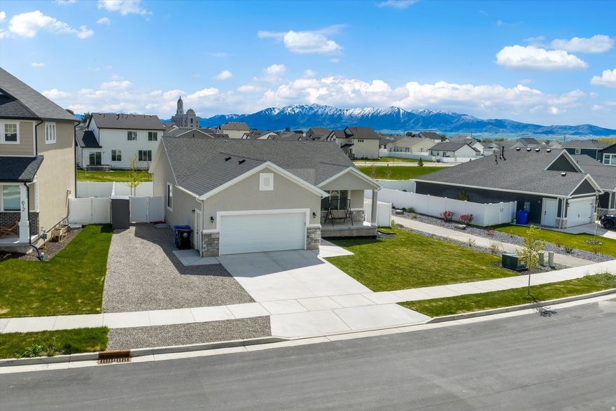 Beautiful Smithfield home in a desirable new neighborhood! This move-in ready property stands out with a fully finished basement and thoughtful upgrades throughout. The basement is set up with a custom built playroom, connected to the family room. The backyard is ready to go with a pergola-covered patio, gas line for a grill, full fencing, and dedicated RV parking. Located just a short walk to the community pool and surrounded by scenic walking trails, this home offers both convenience and lifestyle. Skip the wait for new construction and enjoy a home that's already complete inside and out!