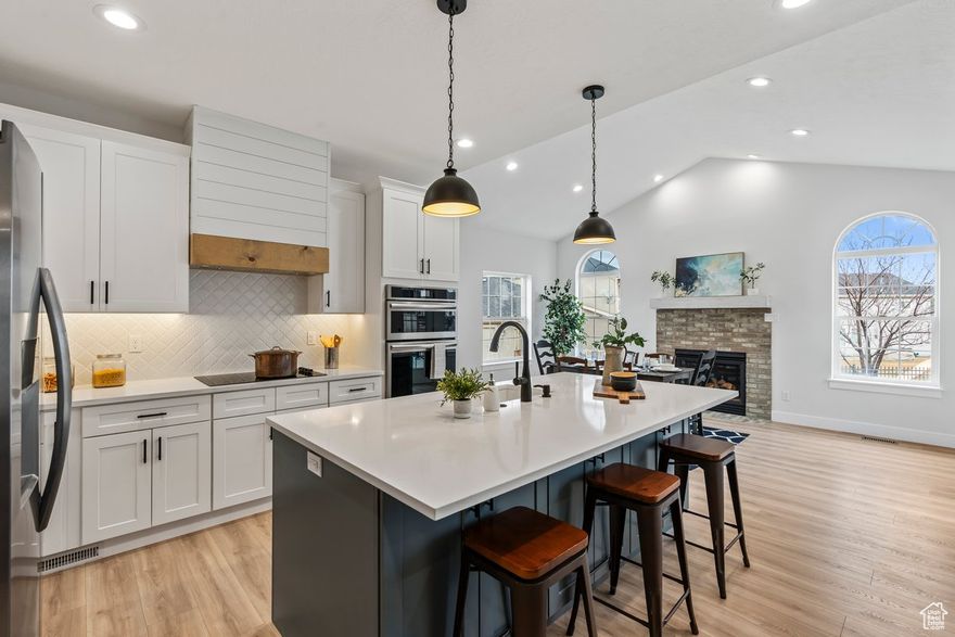 Massive Price Adjustment. Beautiful fully remodeled custom home in highly desired quiet neighborhood with incredible views of lake and mountain and mature trees. Conveniently located minutes from private boat ramp, hiking and biking trails, golf courses, shopping and restaurants, schools, and parks. Complete with Large open concept floor plan, completely upgraded kitchen with Butler pantry and double ovens, Huge Great Room for entertaining guests, primary suite with beautiful shower and separate tub and walk in closet, separate entrance, 2nd kitchen, theater room, .40 acre lot, quartz counter tops, fireplaces, brand new appliances, and more. With separate entrance to basement, extra parking, and full kitchen downstairs home is set up for a nice basement apartment.  Property has access to clubhouse with year round pool, private boat ramp, parks, gym, and walking paths.  Home feels brand new and is easy to show.