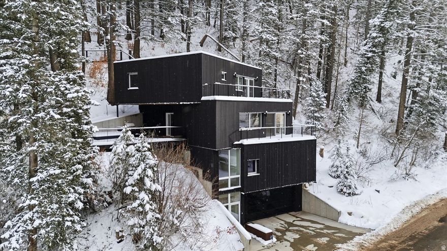 This is a contemporary design and custom built home nestled in the mountains of Summit Park!  Architecturally interesting and functional for daily living. High end finishes throughout- triple pane Zola European windows, designer lighting fixtures, impressive steel staircases, real wood floors throughout,  Main floor is wide open space with attractive kitchen, living room and separate dining area, access to 2 decks- one with a built in kitchen area and firepit, primary bedroom has a sitting room, walk in closet, bathroom with separate tub and steam shower, and access to another usable deck. There is a heated flat driveway and 2 car garage with extra storage space. Move in ready!