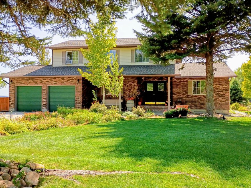 MOTIVATED SELLERS! ALL REASONABLE OFFERS CONSIDERED! Discover peaceful country living in this beautifully maintained 2-story home situated on 1.35 acres in the highly desirable Hillcrest Estates neighborhood, just minutes from Price and Wellington. Enjoy quiet surroundings with no highway or train noise, offering comfort, privacy, and space. This elegant home features over 3,300 sq. feet of living space with thoughtful updates and classic charm throughout. The main level offers an updated kitchen with a breakfast area, a formal dining room with charming saloon doors, a cozy family room with a beautiful brick fireplace and wood stove insert, and a formal living room. The upper level includes three spacious bedrooms, a full bathroom, and a  bath off the primary bedroom. The primary bedroom suite also features a large walk-in closet with built-in drawers and ample shelving. The fully finished walkout basement adds valuable living space with a second family room, bedroom, craft room, and utility room, and provides direct access to the backyard. Outdoor highlights include: automatic sprinkler system, greenhouse, charming sheepherder-style playhouse, established landscaping and two large outbuildings: 8' x 12' and 12' x 20'. Square footage provided as a courtesy estimate from Carbon County Tax Records. Buyer to verify all measurements.