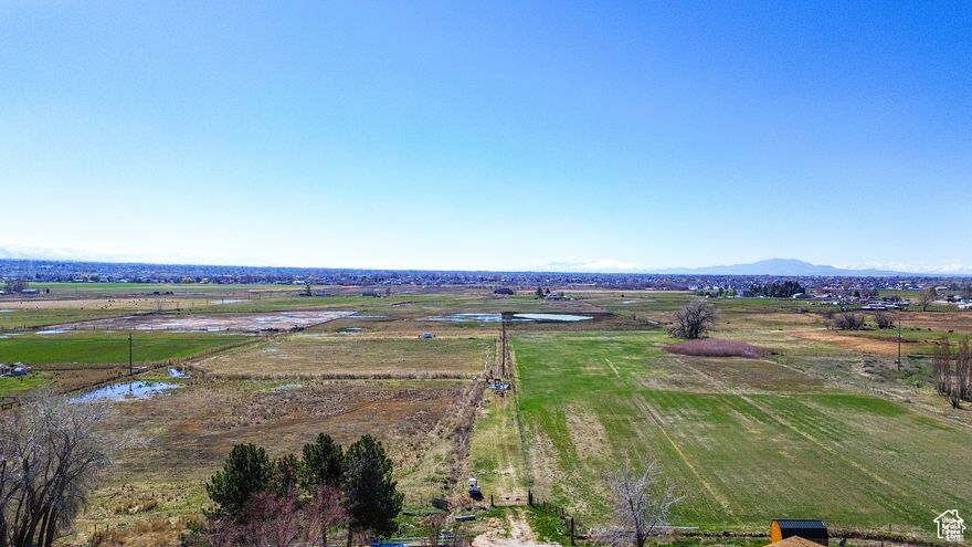 13.62 Piece of ground. $110,000 per acre. Easy development. New junior high and high school under construction. Drive west in 2550 S. Turn South on 4050 W. follow road to end of street.