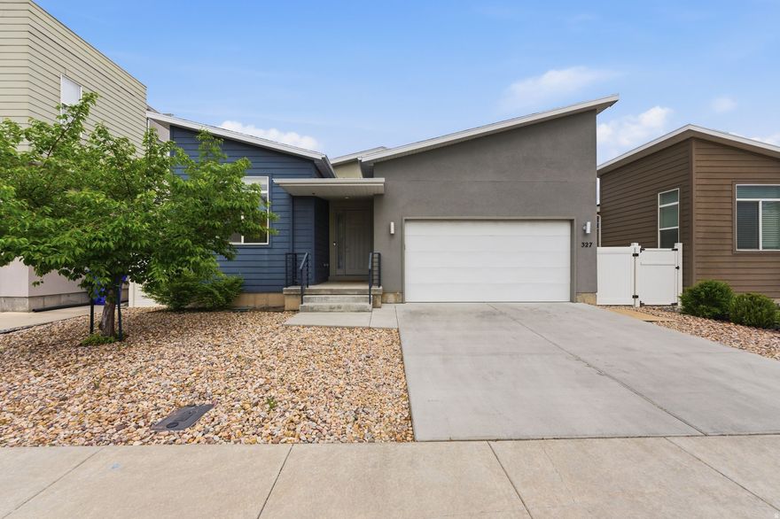 Step into this super cool contemporary stunner, perfectly designed for effortless main-floor living and today's modern lifestyle. From the moment you walk in, you're greeted by a bright, open-concept layout that's ideal for entertaining, connecting, and simply enjoying everyday life. The heart of the home shines with sleek shaker cabinetry, stunning quartz countertops, stainless steel appliances, and a spacious island perfect for bar seating and gathering. A dedicated dining area adds flexibility for both casual meals and hosting friends. Retreat to generously sized bedrooms, including a standout primary suite featuring double sinks, a separate garden tub and shower, and a large walk-in closet; your own private haven to unwind. Step outside to your backyard escape, complete with a spacious deck perfect for soaking up the sun or enjoying those unforgettable Utah summer nights. The fully fenced yard offers just the right balance of space and low maintenance, ideal for kids, pets, or simply relaxing in peace. Xeriscaped front landscaping with drip irrigation keeps things efficient, while the lush backyard lawn adds a touch of green. Enjoy the benefits of paid-off solar panels, included appliances, recessed lighting, brushed nickel finishes, plantation shutters, full window treatments, durable tile flooring in high-traffic areas, and even a luxurious sauna for next-level relaxation and wellness. The location is loaded with convenience, you're just minutes from dining, shopping, schools, colleges, and easy commuter access. Stylish, functional, energy-efficient, and priced to move! This is the one you've been waiting for. Don't miss your chance to call it home! No Showings until the Open House April 25th 2-5.