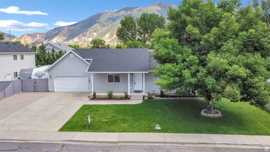 Welcome to this adorable home located in a wonderful, highly desirable neighborhood in Spanish Fork. A perfect place for families and anyone seeking comfort and tranquility in a pleasant setting. This home has a beautiful backyard with abundant trees and a well-maintained lawn, an outdoor oasis ideal for activities, play, and relaxing in the shade of the trees. Through the front door, you enter the living room with vaulted ceilings that provide spaciousness and natural light and new carpet.  Just through the family room is an open-concept kitchen and dining, allowing seamless living and a bright environment. The home has five bedrooms for flexible use, family rooms, a home office, or guest space, three bathrooms offering convenience and functionality for the whole family and a two-car garage with plenty of storage space including ample RV parking! The  wonderful neighbors make this a true home; safe, friendly, and welcoming. Call for a showing today!