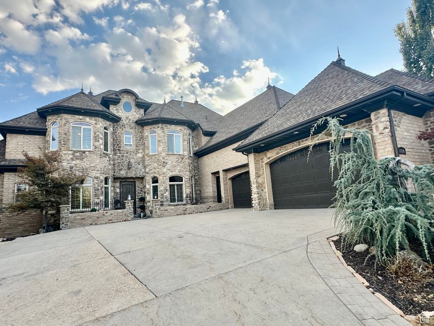 Custom Draper estate with private pool and stunning mountain views, offering over 8,000 square feet of refined living space. The stunning backyard is an entertainer's dream, featuring a gorgeous custom pool with built in rockslide, total privacy with breathtaking views of the Wasatch mountains. Inside, the expansive kitchen and family room boast massive windows that showcase the serene mountain landscape and beautifully designed outdoor oasis. The main floor also hosts a large office and a luxurious primary suite with plantation shutters leading to a covered patio. Upstairs includes a second bedroom suite, 2 additional bedrooms, 2 theater rooms, second office leading to a covered balcony. The large basement includes a kitchen, 2 family rooms, large game room/den, exercise/dance room, den/craft room, storage rooms, second large theater room, steam shower, and walkout covered patio.  Located in one of Draper's most coveted luxury neighborhoods, this exclusive home offers a rare opportunity for elegant living with privacy and space.