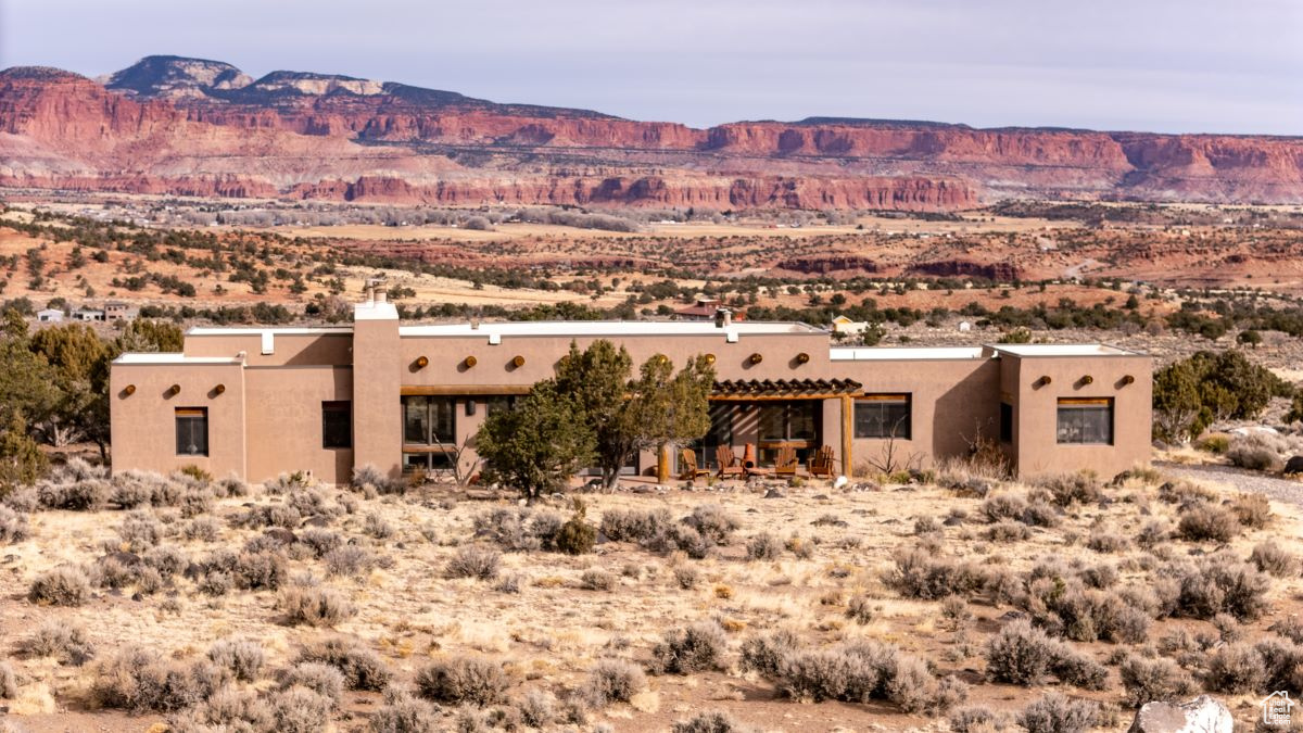 Sitting luxuriously on a fabulous ten-acre parcel, this amazing home is in complete harmony with its natural surroundings. This property is one of those rare places that both the land and the structure are impeccable, and both are ideal. The truly fantastic views in every direction, from the all the windows and porches, are inspiring and invigorating. The powerful cliff face of Thousand Lake Mountain to the north and the lovely Boulder Mountain stretching across the south are Southern Utah's choice sightings. The custom home was designed and well-crafted with care for maximum enjoyment of the wonderful views and presence of nature, as well as a space of comfort and relaxation. The Southwestern style gives the interior a sense of space and style, with the great room in the center and bedrooms on either side. The rounded corners, quality windows with stone sills, concrete floors and horno-shaped fireplaces are some of the features that complement the well-designed floor plan. The welcome winter sun provides passive solar warmth, while the generous overhang provides shade in the summer. With an air of tranquility,the master bedroom has a wall of sliding glass doors for sky viewing and for stepping outside. Accessed from the bedroom, the full-sized master bath is bright and sunny. A comfortable den could also serve as a bedroom. A room currently used as an office also qualifies as a bedroom. The 3/4 guest bath is conveniently located in the hall near the den. One-floor living and native vegetation for landscaping contribute to an easy lifestyle. The home is in excellent condition, very private and desirable in every way. Propane with buried tank, electricity, private well and fiber optics are all connected. Access is from a private road leading from Donkey Flats Road. Vacation rentals and commercial use not allowed. Shown by appointment only.