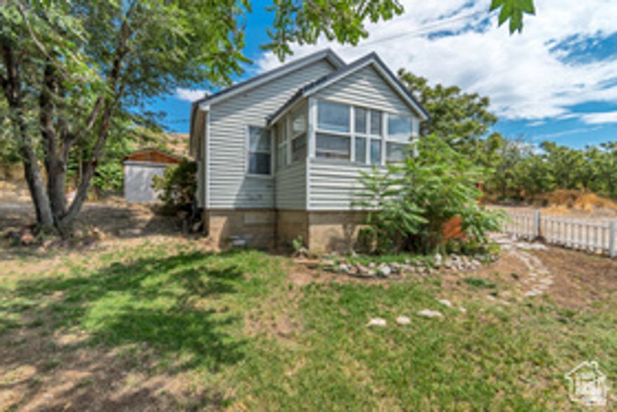 Genola Home on 2.5 acres! Bring the horses, this 2BD home is the perfect way to taste the country and have some land. A beautiful location sits this home nestled in the quiet place people call Heaven! Genola is still hidden from the hustle and bustle. The home is small and sweet. Build that addition and grow the perfect garden. Buyer Broker to verify all square footage and home/land information, as it is a courtesy estimate only. Please use the showing service for appointments. Please provide a few hours notice.