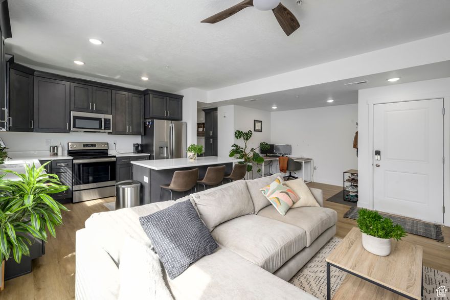 This immaculately clean and nearly brand-new Top-Level Condo is looking for its owner!  This new community borders the Jordan River and offers tons of natural light for your plants, high ceilings, a modern kitchen, and views for days.  This unit has ceiling fans and a custom storage shed at the front of the carport and we are priced well below the brand new options.  Come on by for a peek, fall in love, and let's get into your new home!  HOA does allow long-term rentals!  Buyer to verify all!