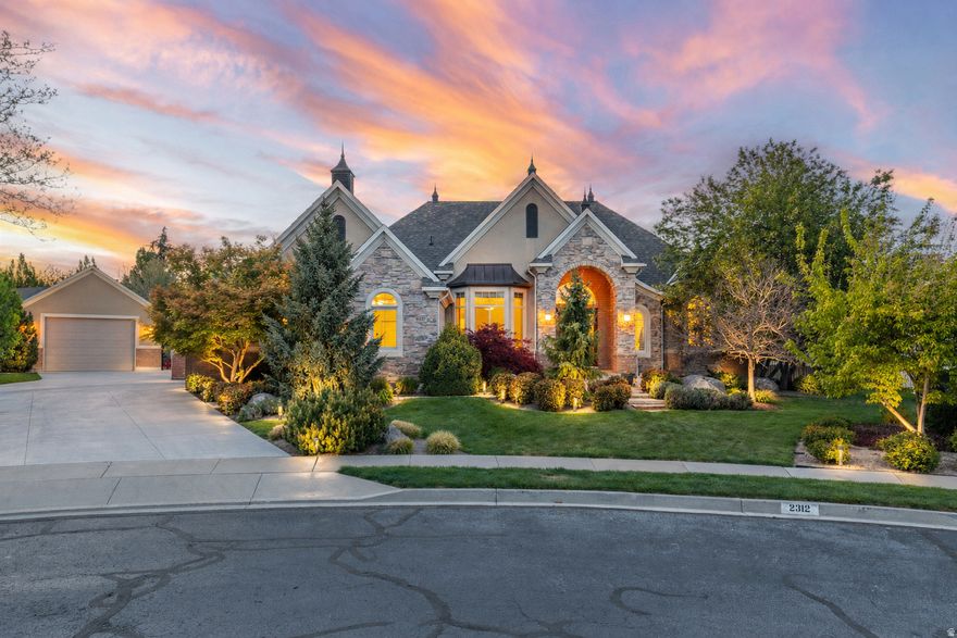 Luxury isn't just built... it's experienced. Tucked within a quiet cul-de-sac in the prestigious Triple Crown Estates, this custom residence is a true expression of craftsmanship, scale, and intentional design. From the moment you arrive, the architecture, mature landscaping, and evening ambiance set a tone that only a home of this caliber can deliver. Step inside to a grand entry that immediately makes a statement; soaring ceilings, intricate ceiling detail, and a stunning chandelier create a sense of arrival, while natural light pours through expansive windows, highlighting the home's refined finishes and thoughtful layout. The main living space is both impressive and inviting, anchored by a beautiful fireplace and framed by dramatic, oversized windows that bring the outdoors in. The seamless connection between the living room, dining area, and kitchen creates a space designed for both everyday comfort and elevated entertaining. The kitchen is a true centerpiece; featuring custom cabinetry, high-end appliances, an oversized island, and rich, timeless finishes that reflect both quality and function. Whether hosting or enjoying a quiet morning, this space was designed to be lived in and admired. The primary suite offers a private retreat, complete with a coffered ceiling, abundant natural light, and a sitting area that creates a peaceful escape within the home. Every detail has been carefully considered to provide comfort, scale, and a sense of luxury. Step outside and the experience continues. The backyard is nothing short of exceptional; an entertainer's dream and a private resort all in one. A heated pool with water features, expansive patio spaces, a custom pergola for outdoor dining, and a beautifully designed pool house create the perfect setting for gatherings, relaxation, and unforgettable summer nights. Whether hosting a large event or enjoying a quiet evening by the fire, this outdoor space delivers on every level. The lower level offers additional flexibility for entertaining, recreation, or extended living, adding to the home's overall versatility and functionality. Surrounded by other custom-built homes and known for its pride of ownership and strong sense of community, Triple Crown Estates offers a lifestyle that is both refined and welcoming, with convenient access to parks, trails, and everyday amenities. This is more than a home; it's a statement of quality, a place to gather, and a property designed to be enjoyed for years to come.