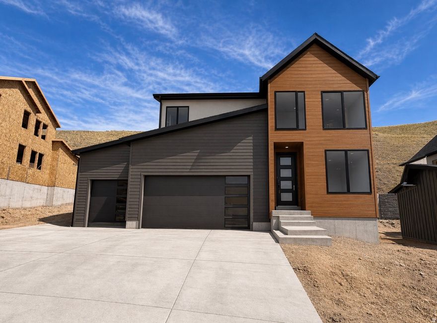 Stunning Summerwood floorplan in builders popular Transitional Architecture with over $216,000 in upgrades! Enjoy breathtaking mountain and valley views all around you in this spectacular home. This beautifully designed 4-bed home is set in the prestigious Canyon Point community on Traverse Mountain. The eye-catching exterior architecture in dark tones with black windows makes a bold first impression. Inside, you'll find a light-filled 2-story great room, A spacious gourmet kitchen with KitchenAid appliances including double ovens, 5-burner gas cooktop, and built in microwave.  An 8' island, tile backsplash to the ceiling, quartz counters with a thick-edge profile, and high quality cabinets to the ceiling finish this kitchen beautifully. The main level features full luxury vinyl flooring, black open railing, and a striking 2-story contemporary fireplace. Includes a 3-car garage and a fully finished basement and laundry room includes high end cabinetry, Canyon Point offers luxury amenities including a resort-style clubhouse, beach-entry pool with lap lanes, tennis and basketball courts, multiple parks, and scenic trails connecting to the canyon. For the time being, Seller will contribute up to $25,000 toward a rate buydown OR take the Seller concession directly off the purchase price for cash offers, or buyers willing to use Sellers preferred lender. Contact the listing agent for full details!