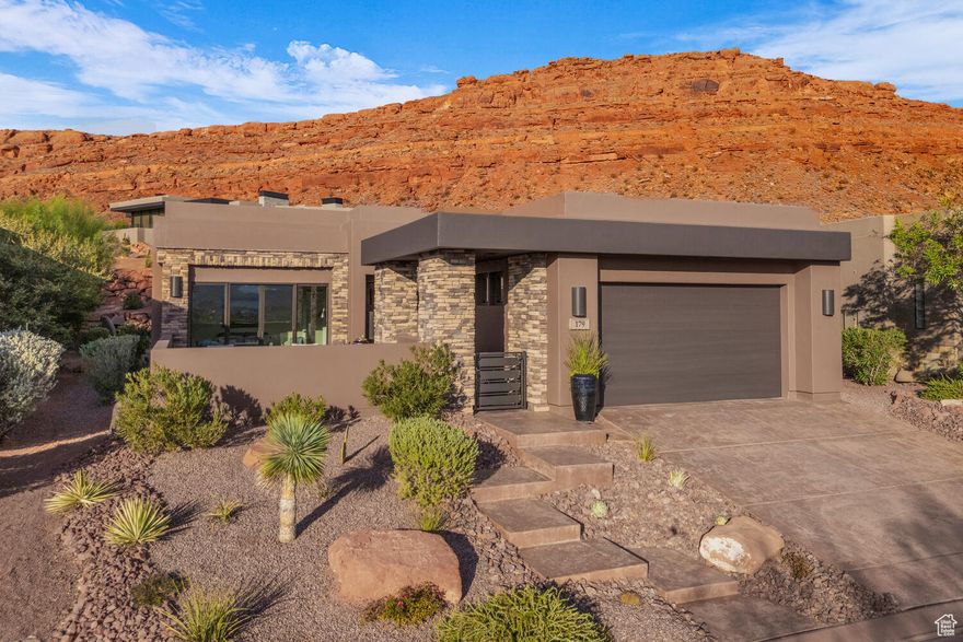 Experience sophisticated desert living in this exceptional contemporary home - the final residence constructed in this highly sought-after community. Designed to capture natural light and surrounding beauty, this immaculate property showcases clean architectural lines, open spaces, and designer finishes throughout. The private backyard is an entertainer's dream, featuring a new privacy wall, soothing water fountain, and multiple patio areas ideal for relaxation or gatherings - all set against the backdrop of breathtaking red rock views.  Interior highlights include a newly added bar area, new flooring, and automated curtains and shades. The chef's kitchen boasts a new oven, new refrigerator, and gas cooktop, complemented by modern cabinetry and sleek surfaces.