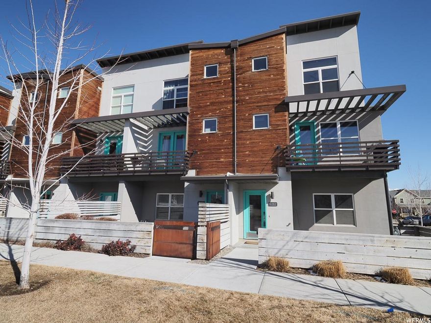 This open-concept, end-unit townhome offers abundant natural light with extra windows and stunning views of the park, as well as the Oquirrh and Wasatch Mountains. Move-in ready, each bedroom features its own private bathroom for added comfort and convenience. A dedicated office/den provides the perfect space for working from home. The garage is equipped with 220V wiring to accommodate most electric vehicles. Ideally located in a walkable community with lakes, trails, and shopping just minutes from your front door.