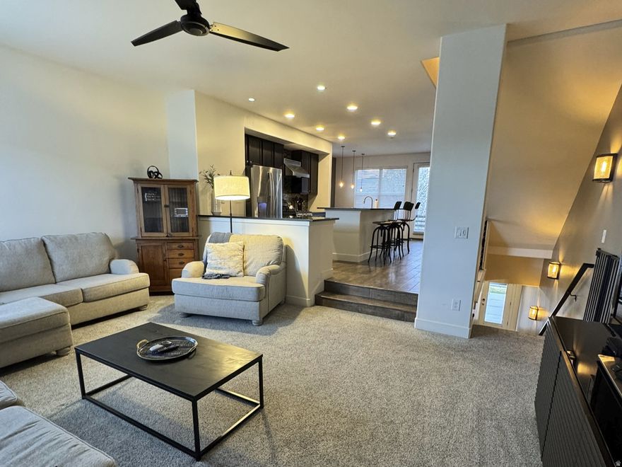 This open-concept, end-unit townhome offers abundant natural light with extra windows and stunning views of the park, as well as the Oquirrh and Wasatch Mountains. Move-in ready, each bedroom features its own private bathroom for added comfort and convenience. A dedicated office/den provides the perfect space for working from home. The garage is equipped with 220V wiring to accommodate most electric vehicles. Ideally located in a walkable community with lakes, trails, and shopping just minutes from your front door.