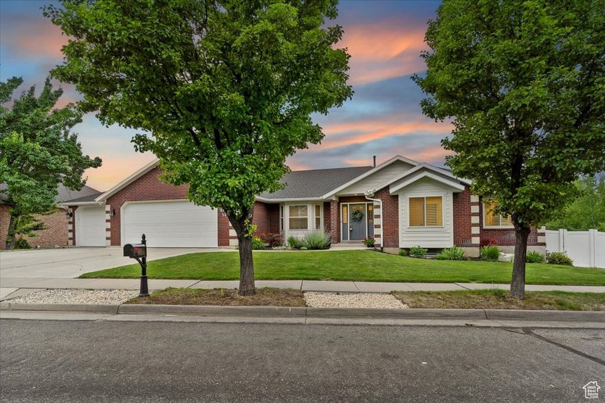 You wouldn't guess it, but behind the sweet red brick exterior of this Foxhill Road home lies a terraced backyard paradise. Step inside, and you'll be happily surprised by the long list of  improvements and features awaiting you.   The comfortable layout is ideal for entertaining. A generous living area, semi-formal dining area, and an open kitchen all connect to a covered patio overlooking the yard with sunset views of the Great Salt Lake. Also on the main level, the luxurious primary suite boasts a fireplace and a recently updated en suite with dual vanities, a soaking tub, a water closet, and a spacious walk-in closet.  The home's lower level offers an abundance of space with three additional bedrooms, a rec room with a fireplace and wet bar, and a flex space under the garage that's currently used as a home gym. This level opens to the lower patio, where you'll find a hot tub and access to the backyard wonderland. If summer isn't already your favorite season, it definitely will be once you're relaxing in the decked-out pool of your dreams-complete with a slide, diving board, automatic cover, and pool house. As if that wasn't enough, the yard also has a putting green. If you'd like to take your golf skills off-property, the Eaglewood Golf Course is less than a mile away. Options for outdoor activities abound in North Salt Lake, with many parks, hiking trails, and bike paths.