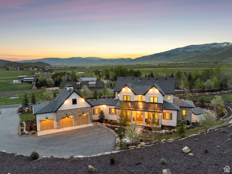 Brilliantly Designed On 1.55 Acres, Perfectly Landscaped Kamas Estate   This perfectly designed home has the most amazing finishes throughout, offers main floor living and has stellar views to the Kamas Valley and Uinta Mountains. It's a modern farmhouse with warm color palettes of wood, brick and rock, creating the inviting home that bridges contemporary with a farm house vibe. The main floor offers an inviting great room with a chef's kitchen all opening to an amazing patio area perfect for outdoor movie watching and morning coffee. The primary bedroom is also on the main level offering beautiful valley views, a stunning bathroom with a soaker tub and oversized shower plus a large walk-in closet. Upstairs you'll find two private guest rooms and an office offering some of the best views in the home. The downstairs walk-out family room is perfect for an additional living space that features a wet bar, room for a pool table, versatile theatre room, a brick wine room and plenty of space to entertain or snuggle in at home. You can walk out to the private back yard that features a hot tub area and designer shed. There's also two additional large bedrooms on this level. The home boasts multiple porches, decks and private patios perfect for enjoying the summer evenings. The home has unbelievable landscaping design emphasizing the valley views from almost every window. You'll enjoy being tucked in the Kamas Valley, and yet just 15 minutes to downtown Park City and the slopes.