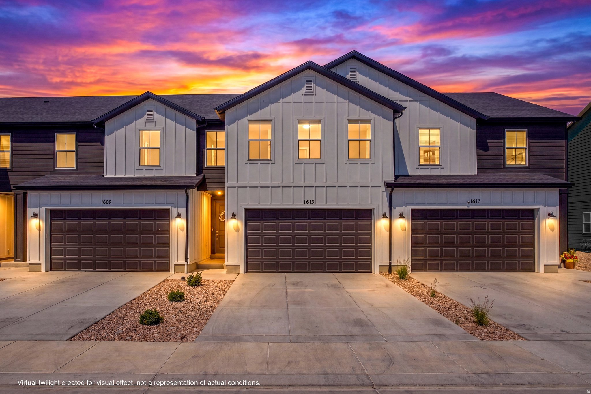 Modern townhome exterior with dark siding and white board and batten accents