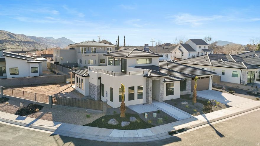 !! Seller is offering a 3% Buyer Incentive during the 2026 St George Parade of Homes!!! Take it off the purchase price, buy down your interest rate, have us finish the landscaping, apply it toward a pool, add a hot tub or window treatments!! So many options!! Incentive based on a full price offer. Brand New Home situated on an extra-large, premium view lot-designed for the way you live and play. This beautiful 3 bed, 2 bath Madsen Custom Home features a spacious great room that flows to an outdoor living space under the covered patio. The upper bonus/rec room opens to another incredible out door space on the rooftop deck - perfect for sunrise coffee or sunset wine while taking in the unsurpassed views.   Featuring Quartz countertops, Knotty Alder cabinetry, Butler Panty, Luxury Vinyl Plank flooring and unique tile throughout. The Primary Suite offers an extra long, double vanity, oversized shower and walk-in closet.  Modern finishes, the thoughtful design including the expansive windows bringing in the natural light and  breathtaking views; along with the attention to detail and quality workmanship make this one you definitely don't want to miss!  RV Parking area along with the double-tandem (4-CAR) garage offers room for all the toys. The garage features a second overhead door in the rear for ease of access. The sprawling .27 acre lot give you plenty of room for a future pool and much more!  Centrally located with quick access to all the outdoor adventures Southern Utah has to offer.  Biking, hiking, golfing, UTV riding, boating, fishing and more! .Just 30 minutes away from Zion National Park and St George and 15 minutes from Sand Hollow & Quail Creek Reservoirs. This IS Southern Utah LIVING!