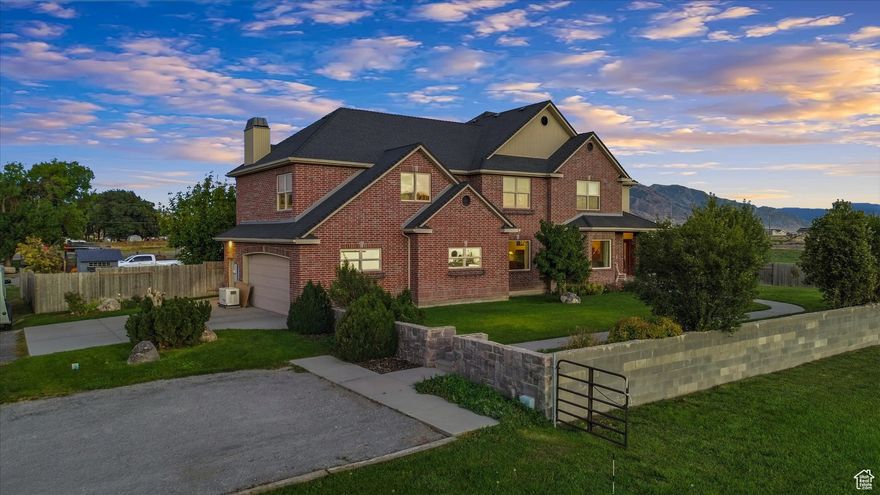 Hey, check out this stunning two-story brick home, conveniently tucked near I-15 and Valley View Highway for easy commutes to Ogden and Logan. Spanning almost 2 acres, it's perfect for horse enthusiasts, with plenty of room for your horses to roam, a beautifully appointed barn featuring a generous tack room, and a serene private orchard. Head inside to the main level for easy, everyday elegance: there's a spot just for dining and a comfy living room with a toasty fireplace to chill by. The kitchen's a gourmet haven, elegant and spacious, with luxurious tiled countertops, an enormous island ideal for prepping feasts and entertaining, a premium separate cooktop, wall oven, and built-in microwave-perfect for passionate cooks whipping up delicious meals after a day outdoors. Enjoy the spacious primary suite, complete with a walk-in closet, walk-in shower, and your own fireplace for those relaxing evenings. Upstairs, you've got four extra bedrooms, two bathrooms, and a spacious family room that's great for family time, having friends over, or whatever hobbies you enjoy. Downstairs, the basement is all yours to customize-it's unfinished and ready for your ideas. Out back, the driveway's set up smart for easy pulling in and out with all your trailers, no hassle. And that big, enclosed back porch/sunroom? It's the perfect place to unwind year-round, especially while catching the sunrise over your own spread of land. Blending acreage, features for your horses, and everyday comfort, this home is waiting for you to make it yours-Call to schedule your viewing today!