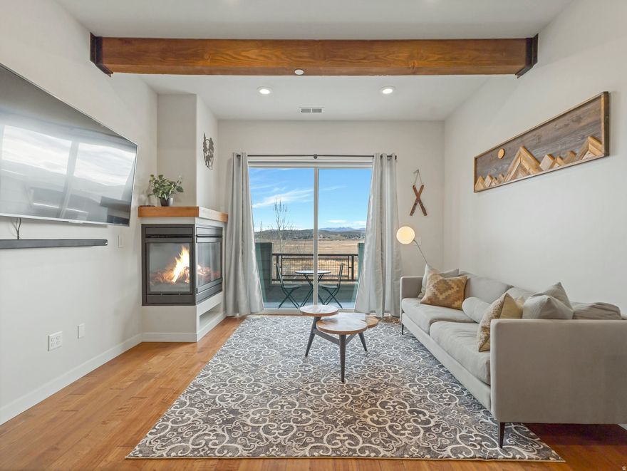 Step inside this 2-bedroom, 2-bathroom Newpark Terrace townhome and be instantly drawn to the breathtaking, unobstructed views of the Swaner Preserve. Whether you're sipping coffee as the morning sun rises over the wetlands or watching wildlife from one of your two private patios, the scenery feels like a living masterpiece framed by your large sliding glass doors.  The lower-level ensuite bedroom opens directly to a spacious patio-ideal for soaking in the hot tub on snowy winter nights or lounging on summer afternoons. Upstairs, the open-concept great room and kitchen showcase rich wood beams, high ceilings, and upscale finishes, all oriented to maximize the Swaner Preserve views. A second ensuite bedroom offers privacy while maintaining easy access to shared living spaces.  A private garage keeps your gear secure, and the gated community provides peace of mind. Located in the heart of Kimball Junction, you can walk to trails, dining, shopping, grocery, and entertainment. Whether you choose to generate income with nightly or long-term rentals or keep it as your personal mountain getaway, this is a rare opportunity to pair convenience with unmatched natural beauty.