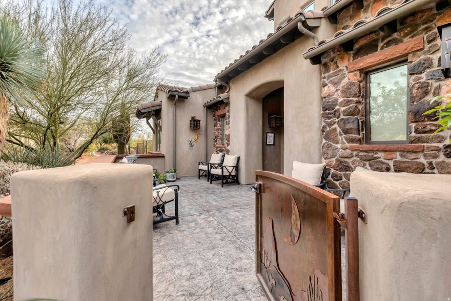 Located in the exclusive Whisper Ridge subdivision, this former Parade of Homes model offers incredible views and a layout designed for comfortable luxury. The great room features 20' vaulted ceilings, custom wood beams, and detailed ironwork that make a strong first impression. The upgraded kitchen includes Wolf/Sub-Zero appliances and custom lighting throughout. The large primary suite adds extra flexibility with an attached sunroom that works perfectly as a private office or studio. With no neighbors behind you, the backyard becomes a true extension of the home-complete with a Cowboy Kitchen, built-in BBQ, refrigerator, a massive outdoor rock gas fireplace, and Bullfrog hot tub.  It's a private setting built for everyday living and easy entertaining. Homes in Whisper Ridge rarely come available-this one is ready to be enjoyed.