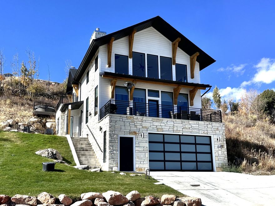 Experience modern mountain living at its finest in this beautifully designed Bear Lake retreat. Built in 2021 and curated with high-end furnishings throughout, this turnkey home blends comfort, style, and adventure - making it the ideal year-round escape. While perfect as a private getaway, it also offers a unique opportunity to enjoy the lake lifestyle and have it pay for itself. With a strong track record of high occupancy year round, this property performs exceptionally well as a short-term rental, yet still feels like a true second home. The open floor plan invites gathering, while the garage transforms into a fully equipped entertainment zone - complete with basketball hoop, darts, foosball, and a cozy movie space. Just minutes from the marina, beaches, and Garden City dining, this home is fully furnished, thoughtfully laid out, and ready to enjoy or continue operating as a proven rental success.