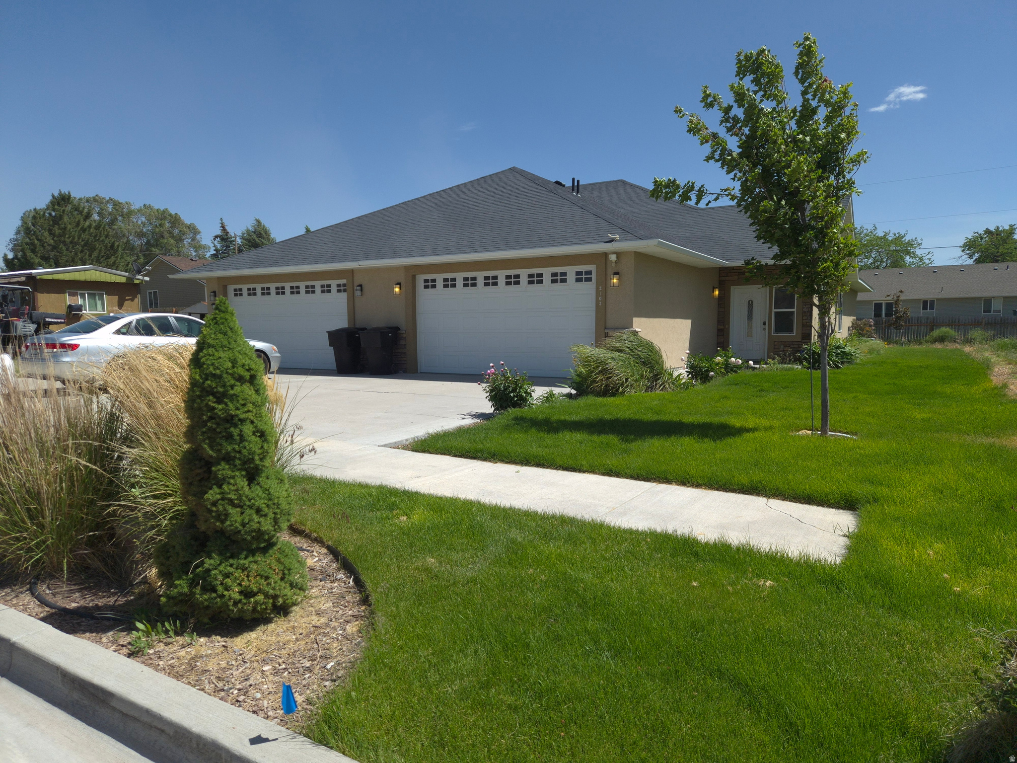 Duplex property featuring a tan exterior with white trim