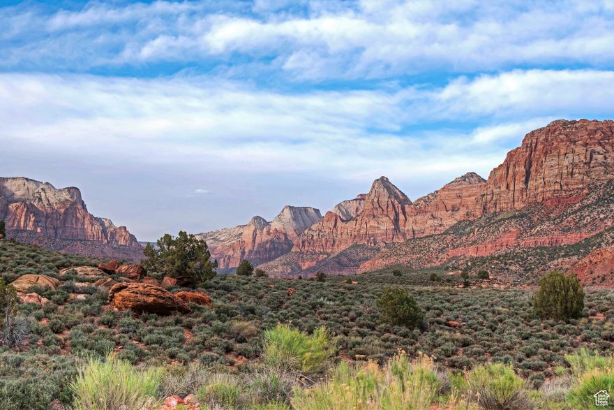 Zion Overlook lot in Springdale has the most magnificent panoramic view of Zion Canyon! Enjoy a birds-eye view looking directly into Zion Canyon with the majestic red rocks towering on both sides with the rich, green Virgin River Valley in the foreground. Enjoy the iconic Zion cliffs as they light up to brilliant shades of orange and magenta at sunset! Stargaze into the twinkling dark sky after nightfall where the Milky Way shines brightly. This is the ultimate Zion view lot, with stunning 360-degree views of Zion! Perched on a knob overlooking Springdale, this lot offers ultimate privacy! Fiber Optics are available so you can be connected even while you enjoy the best that nature has to offer. We can suggest architects and builders, familiar with the area, who can help you create your dream home