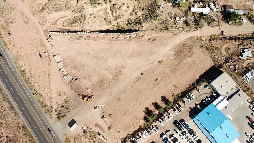 Discover the perfect investment property in the heart of Moab! Located at 1741 S Highway 191, this 3-acre commercial parcel offers unmatched visibility and accessibility, directly across from the newly developed Moab college campus. The seller is willing to consider seller financing and has reduced the price to $1.59M from $1,699,999, creating an exceptional opportunity for investors and developers. Don't miss this rare chance to own a prominent piece of Moab's commercial corridor with strong income and development potential. Contact us today to schedule a viewing or learn more!  All renderings, conceptual site plans, layouts, and mockups are provided strictly for marketing and illustrative purposes only. Designs shown are preliminary concepts and do not constitute engineered plans, approved site plans, surveys, or development approvals. Property lines, setbacks, easements, access points, parking layouts, building placements, UDOT right-of-way boundaries, utility locations, and development potential are approximate and subject to verification, governmental approvals, engineering review, and final design modifications. No guarantee or representation is made regarding feasibility, entitlement, permitting, or final approved use of the property.  There is a known storm drain easement affecting portions of the property that will require consideration and coordination with qualified architects, engineers, surveyors, and/or governmental authorities during any future development or planning process.  All mockups, renderings, marketing concepts, and related materials are proprietary marketing materials created for and owned by the Listing Brokerage. These materials are non-transferable and may not be reused, reproduced, distributed, modified, or relied upon by third parties without prior written consent from the Listing Brokerage.