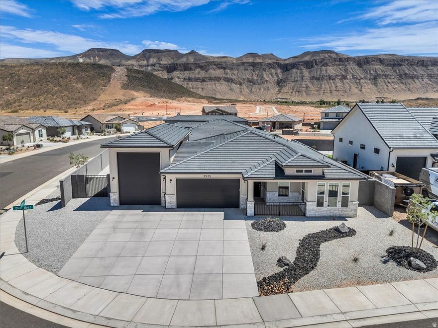 Custom home in Hurricane offering modern design and an unbeatable location just minutes from Copper Rock Golf Course and Sand Hollow Reservoir. This thoughtfully designed home features a bright open-concept layout with 2X6 exterior walls, LVP flooring, abundant natural light, and a stylish kitchen with quartz countertops, white cabinetry, a large island, and stainless appliances. The primary suite includes a spa-like bath with soaking tub, walk-in shower, and dual vanities. Additional upgrades include finished window trim, quartz countertops, water softener & hot water circulation pump. Enjoy a low-maintenance, fully fenced yard, 16 X 43 insulated RV Garage, and easy access to outdoor recreation, dining, and more