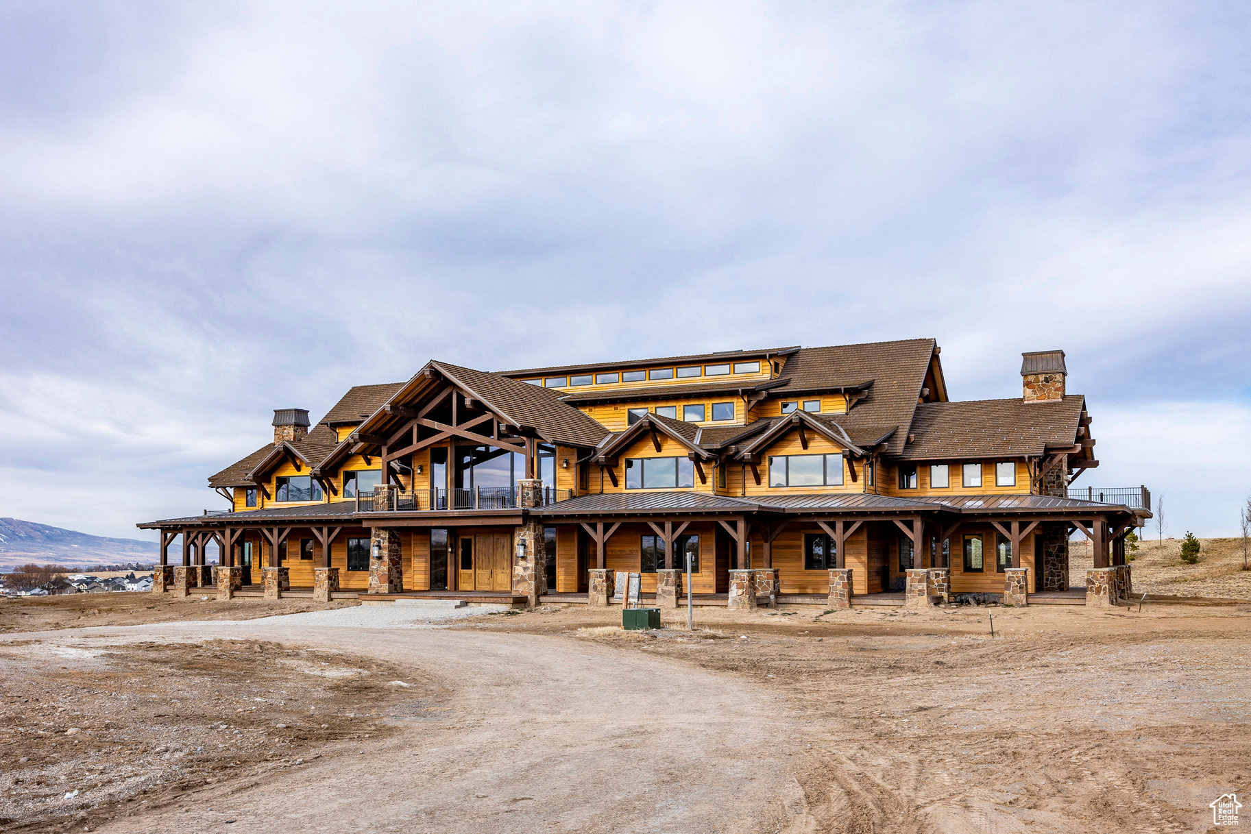 This property is unlike anything you have ever seen. It was designed to be a family retreat, and with just over 70,000 square feet this residence is far larger than anything else in Utah. It consists of a 40,807 sf main house, a 27,080 sf pool barn, and a 2,266 sf tunnel that connects them together. The main house is a five-level western ranch design standing 45' tall. In addition to a beautiful primary suite, there are seven-bedrooms all similarly designed with vaulted ceilings, walk-in closets, wet bars, and full bathrooms. There are several Disney-themed spaces in the property including two incredible bunkrooms (one for the boys and one for the girls) that are done in the spirit of the Swiss Family Robinson. There is also a full replica of the Tiki Hut at Disneyland. The main level is an enormous open space with one side consisting of a kitchen and dining room with a forty-two-seat table and the other side a great room with multiple seating areas. The lowest level has a huge theater room as well as an underground raceway that circles the footprint of the building and gives access to the tunnel, which is around 140' long with four chambers. Walking down it feels like you are in an episode of Star Wars. The pool barn is an incredible 53' tall and once finished will house a swimming pool, exercise area, and large event-type space. Parking is not a problem. The main house garage (called the Bat Cave) can easily fit four vehicles and the pool barn has a 16-car garage. The land is ideal horse property and is approximately 152 acres with gated access off Highway 165 in Hyrum. It is close to Blacksmith Fork Canyon and Hyrum Reservoir, 15 minutes to Logan, and 75 minutes to Salt Lake City and the airport. In addition to the main house and pool barn there is a guest house, five-bay shop, an airplane hanger/garage, a well house, and a large pond that is near completion. Not all of the property is fully finished and we can provide qualified buyers with more details. Priced far below cost.