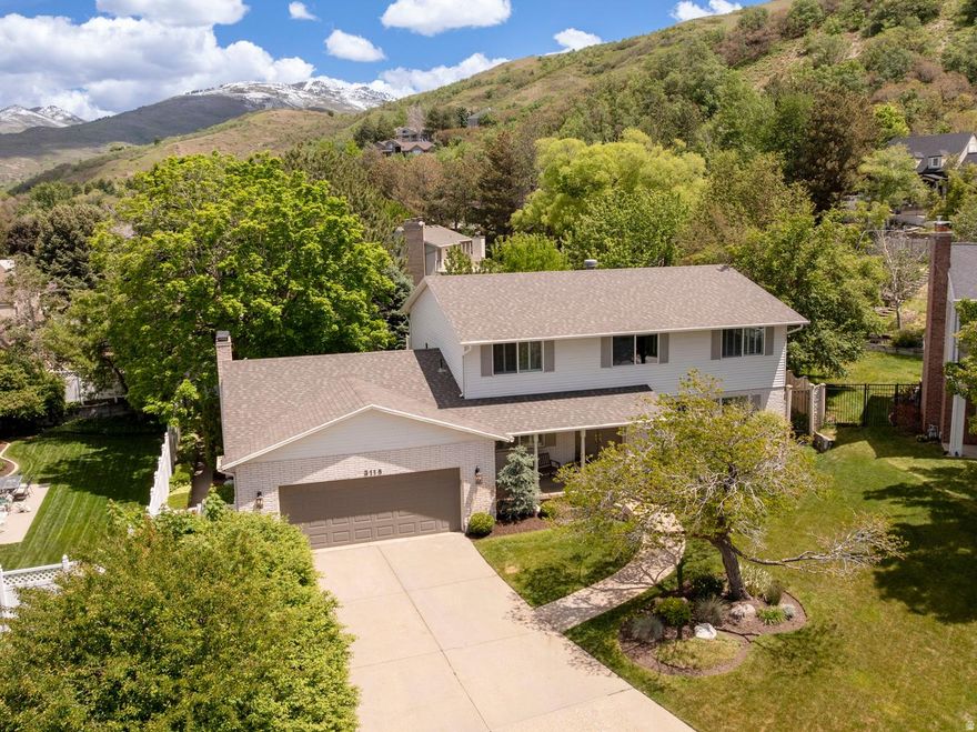 This beautiful 6-bedroom, 5 bathroom home, has a spacious 2-car garage and includes a finished basement with separate entrance providing potential for a future mother-in-law apartment. Hardwood floors, plantation shutters, skylights, French glass doors, and abundant natural light create a warm and inviting feel throughout. The oversized primary suite features a private deck, jetted tub, dual sinks, and large shower with steam option.  Designed for comfort and entertaining, the home includes 3 furnaces, 2 AC units, central vacuum, and generous storage throughout, including cold storage with built-in shelving, a large laundry room, and multiple refrigerators/freezers. The kitchen is equipped with a gas cooktop, double ovens and a large dining area.  The fully landscaped and fenced backyard is truly summer-ready, featuring mature trees, a covered tile patio, adjacent deck, large shed, and a sand area perfect for a firepit or sandbox. Ideally located near Bountiful Ridge Golf Course and Mueller Park Canyon with quick access to hiking and biking trails. This lovely home won't last long! Buyer to verify any and all provided information.