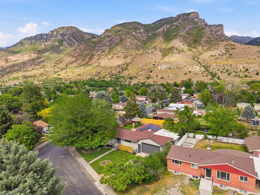 Gorgeous suburban homestead with an amazing kitchen and light-filled gathering spaces. Mountain views and covered back patio to enjoy them from. Multiple fireplaces and large workshop for your bikes, paddle boards, and other outdoor toys. Updated in all the right ways. Plenty of land for gardening, chickens or honey bees.  The basement has a kitchenette and separate entrance.   Hop on a trail for a adventure in the foothills on the weekend and you still have easy access to the freeway for your quick commute to work. Square footage figures are provided as a courtesy estimate only and were obtained from county records.  Buyer is advised to obtain an independent measurement. Call today to schedule your showing.