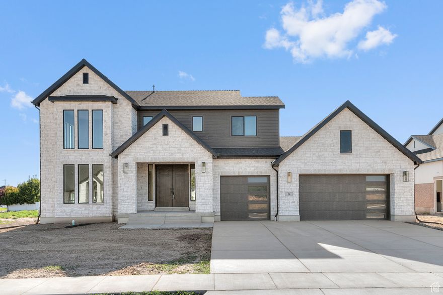 Step into this luxurious Brinton Signature-a thoughtfully designed home in a great Kaysville community! Interior highlights include can lighting, a Christmas and flood light package, a ceiling fan and barn door in the owner's suite, and stylish shiplap accents in the office. The owner's bathroom is a true retreat with tile surrounds and black matte hardware, while textured walls, 2-tone paint, and a grid accent wall in the loft bring designer flair. Finished with Roosevelt base and casing, this home blends craftsmanship with everyday convenience. A Chef's kitchen features custom cabinets with LED lighting, quartz countertops, tile backsplash and stainless steel gas appliances with double ovens. Enjoy elegant laminate hardwood, tile, and carpet flooring along with a cozy gas log fireplace in the great room. This home boasts a 3-car garage with an exit door, 9-foot basement foundation walls, and premium energy upgrades like a water conditioning system, gas lines to the BBQ and dryer, and USB outlets in the owner's bedroom. This home won't last long so come check it out today!