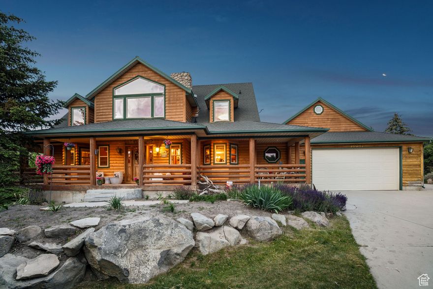 Experience a perfect blend of rustic charm and modern luxury in this stunning log home. Massive windows frame breathtaking views, showcasing nature's beauty through every season. Step onto the expansive front and back decks, perfect for entertaining guests or unwinding on the porch while soaking in the serene surroundings. Enjoy wildlife and mountain views as your daily entertainment. Located on 3.18 acres in High County Estates, just 1.6 miles up a year-round dirt/gravel road to paradise. Culinary water is provided by the City of Herriman and septic tank for sewer. The vaulted great room is a true centerpiece of this home - a soaring space of light and air, where you can relax by the fire. The main floor primary suite and 2 spacious upper-level guest bedrooms, plus 3 baths (and a half bath in the garage), provide plenty of room for family and guests. Thoughtfully crafted with wood flooring, knotty alder cabinetry, and warm countertops, newer appliances, PLUS a loft family room, add to the expansive feel. The unfinished walk-out basement allows for expansion as your needs require. The garage has space for up to six cars or a mix of toys and autos. Add the corral to the east of the property, the garden spot and enjoy rural living just minutes from civilization.