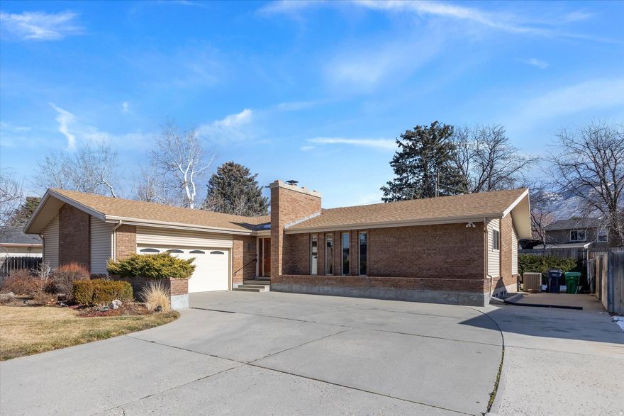 A refined rambler (ranch-style) home with main-level living on the upper eastside of Sandy, offering space, serenity, and a thoughtfully designed outdoor retreat. Set on a flat .23-acre lot, the lush, landscaped yard and fully functioning cascading waterfall create a peaceful, enduring backdrop for everyday living. Inside, enjoy 3,500+ sq ft, 6 bedrooms, 3 bathrooms, a main-level primary suite, multiple living areas, and a finished basement. Smart upgrades include a smart thermostat, Trimlight permanent programmable exterior lighting, Ring video doorbell, and exterior Ring floodlight cameras. Located minutes from Big Cottonwood Canyon and Little Cottonwood Canyon, with convenient access to year-round outdoor recreation, parks, shopping, dining, and commuter routes.
